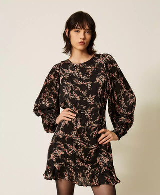 Model wearing the Twinset floral satin mini dress featuring voluminous long sleeves, smocked cuffs, a relaxed silhouette and ruffled hem.