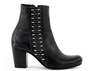 Black ankle boot with metallic stud details on a white background