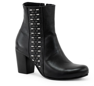 Black ankle boot with metallic details on a white background