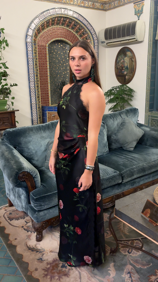 Full-length view of black floral halter maxi dress with rose print
