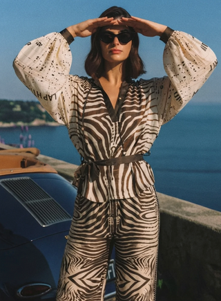 Woman wearing ME369 Rona zebra print belted shirt with puff sleeves